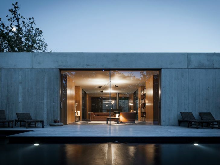 A yard view of the HiFinity Sliding System on a modern concrete house.